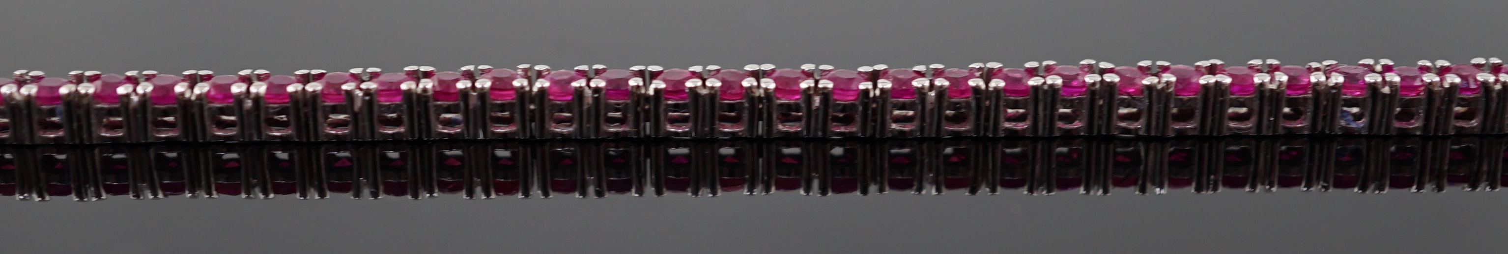 A modern 18k white gold and ruby set line necklace